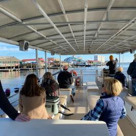 a group of people riding a boat of Southport Water Tours