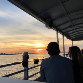 two people sitting on a boat of Southport Water Tours