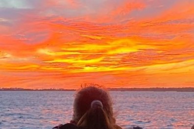 a woman looking at a large body of water