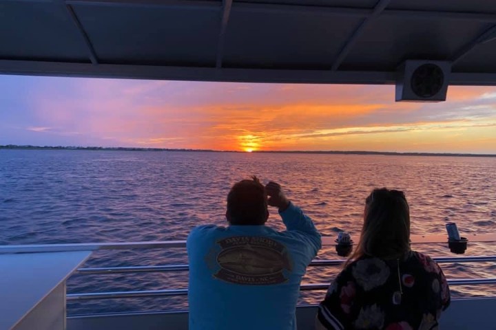 a man and woman sitting in front on a boat of Southport Water Tours