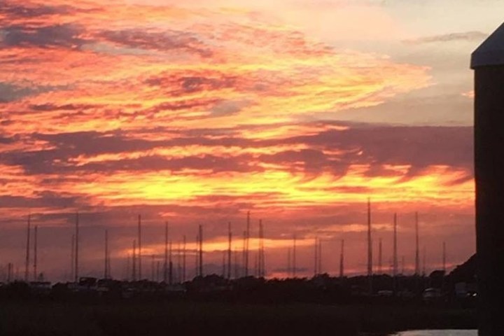 a large tall tower with a sunset in the background