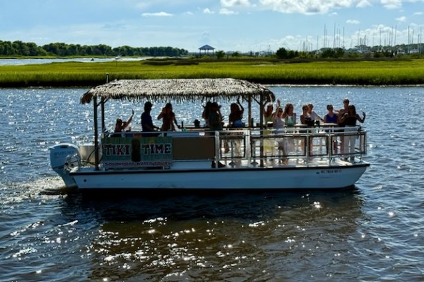 a group of people in a small boat in a body of water